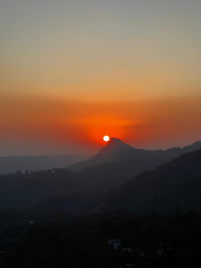 The Panoramic Getaway Hotel Munnar Exterior photo Sunset over Mount Apo
